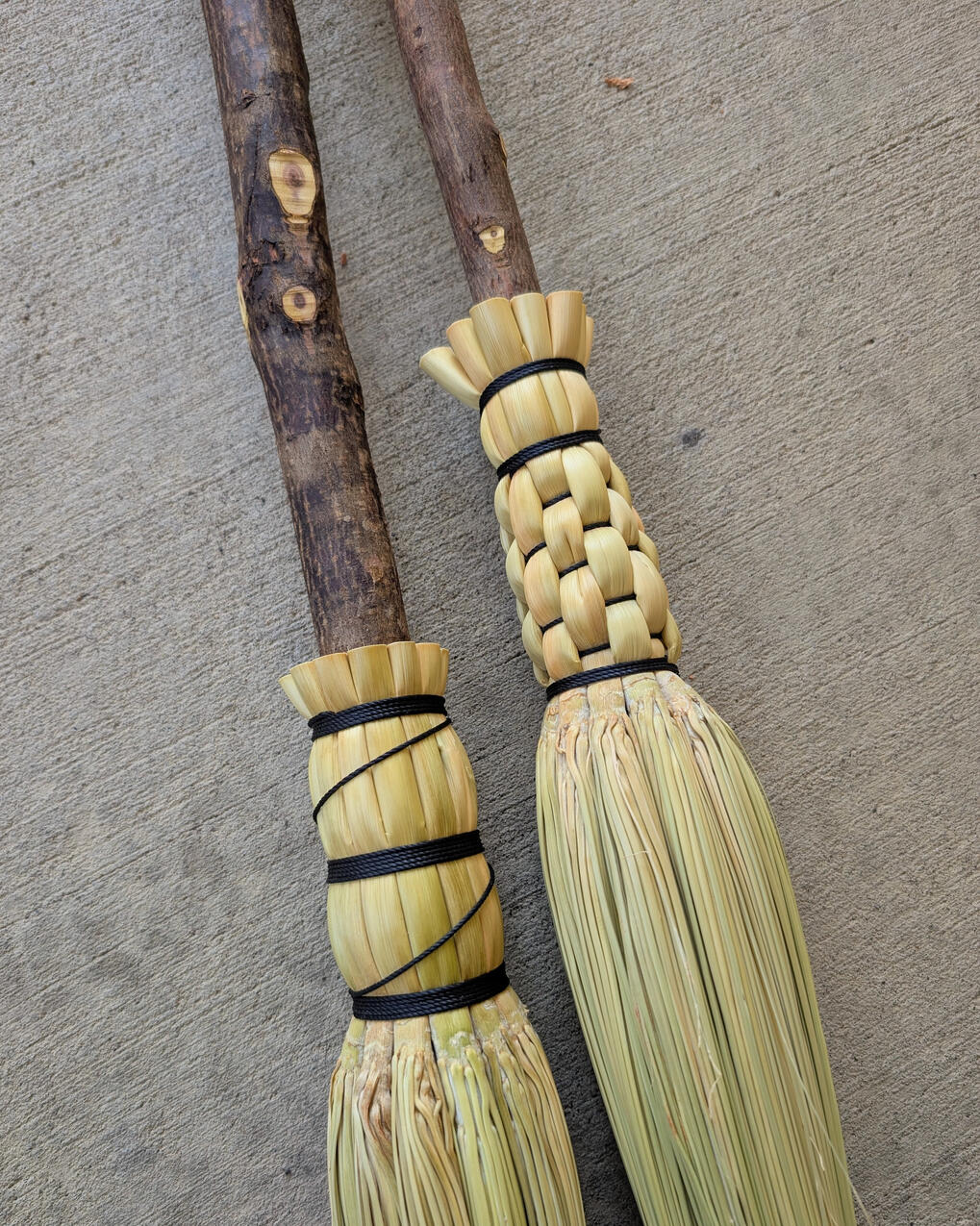 Cobwebber Broom Close up of two cobwebber brooms with rustic handles.