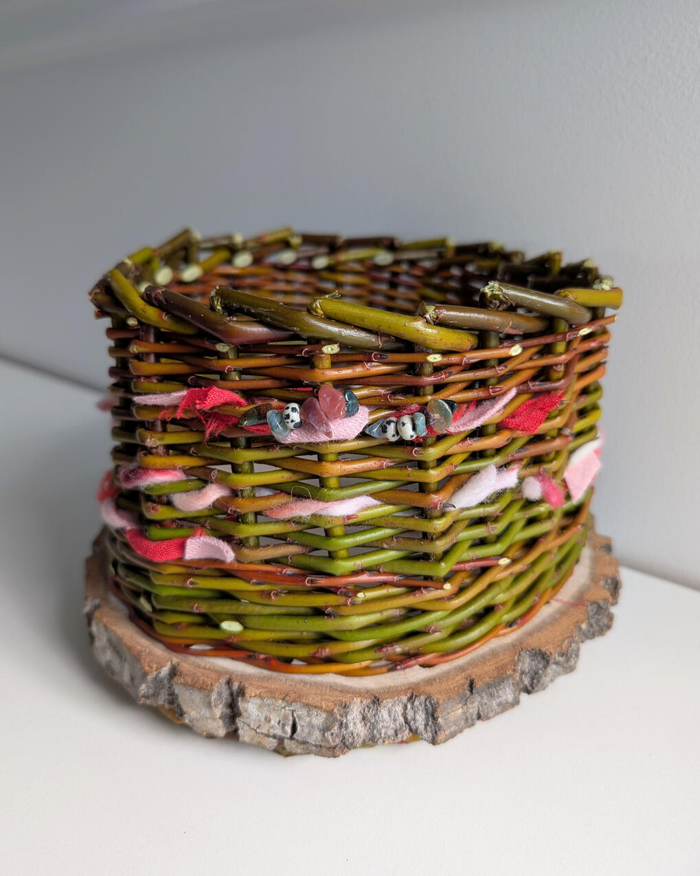 Creative Basket Willow basket with yarn and beads woven into sides.